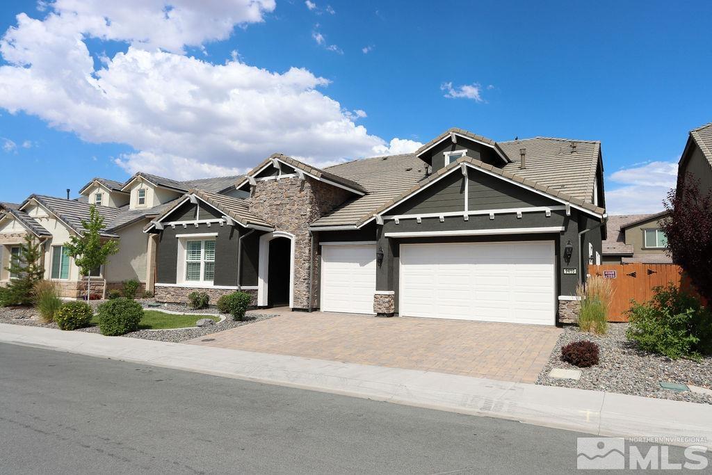 9410 Stony Hill Road Reno, NV 89521 - Photo 2 of 39 a front view of a house with a yard and garage