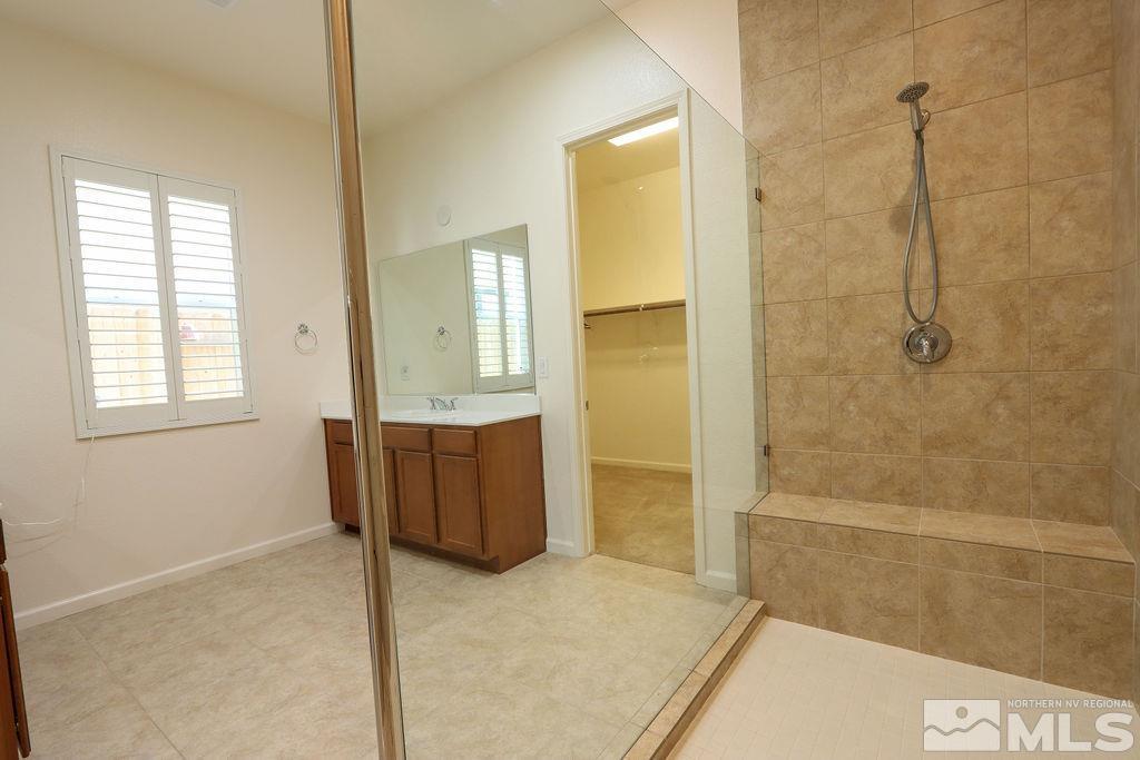 9410 Stony Hill Road Reno, NV 89521 - Photo 25 of 39 a bathroom with a tub shower and sink