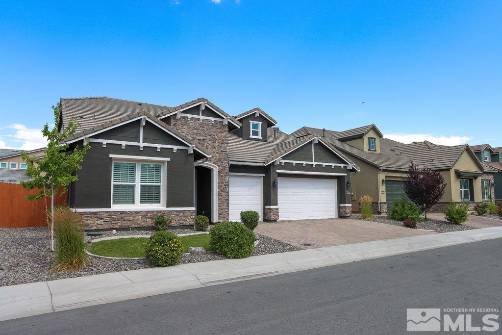 9410 Stony Hill Road Reno, NV 89521 - Photo 3 of 39 a front view of a house with a garden and plants