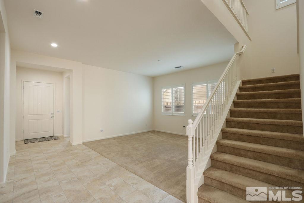 9410 Stony Hill Road Reno, NV 89521 - Photo 32 of 39 a view of staircase with wooden floor and white walls