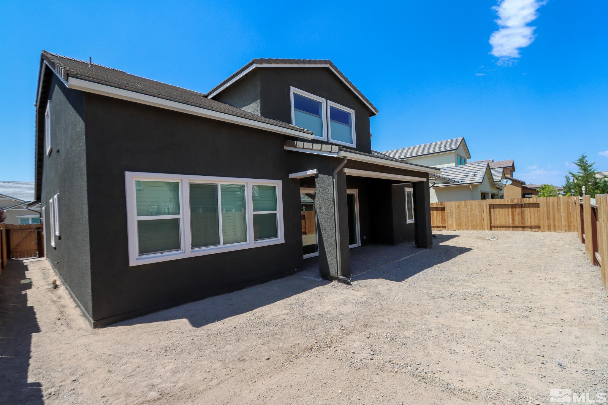 9410 Stony Hill Road Reno, NV 89521 - Photo 5 of 39 a front view of a house with a yard
