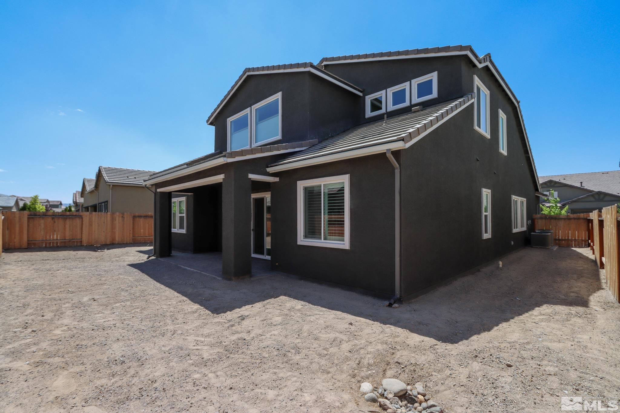 9410 Stony Hill Road Reno, NV 89521 - Photo 7 of 39 a front view of a house with a yard