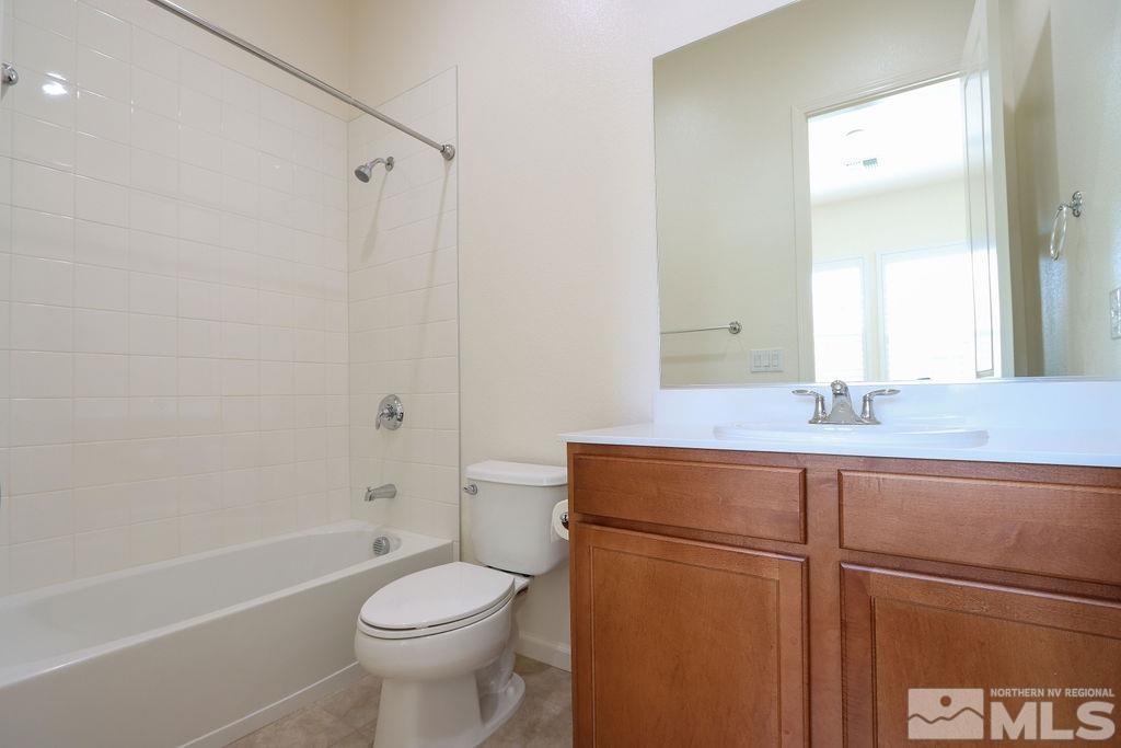 9410 Stony Hill Road Reno, NV 89521 - Photo 10 of 39 a bathroom with a granite countertop toilet sink and mirror