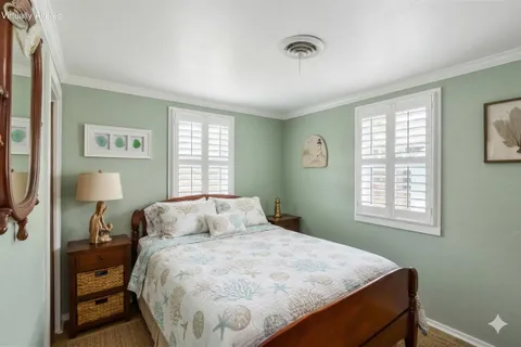 a bedroom with a bed and a lamp next to a window
