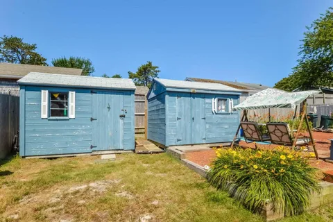 a view of a house with a backyard