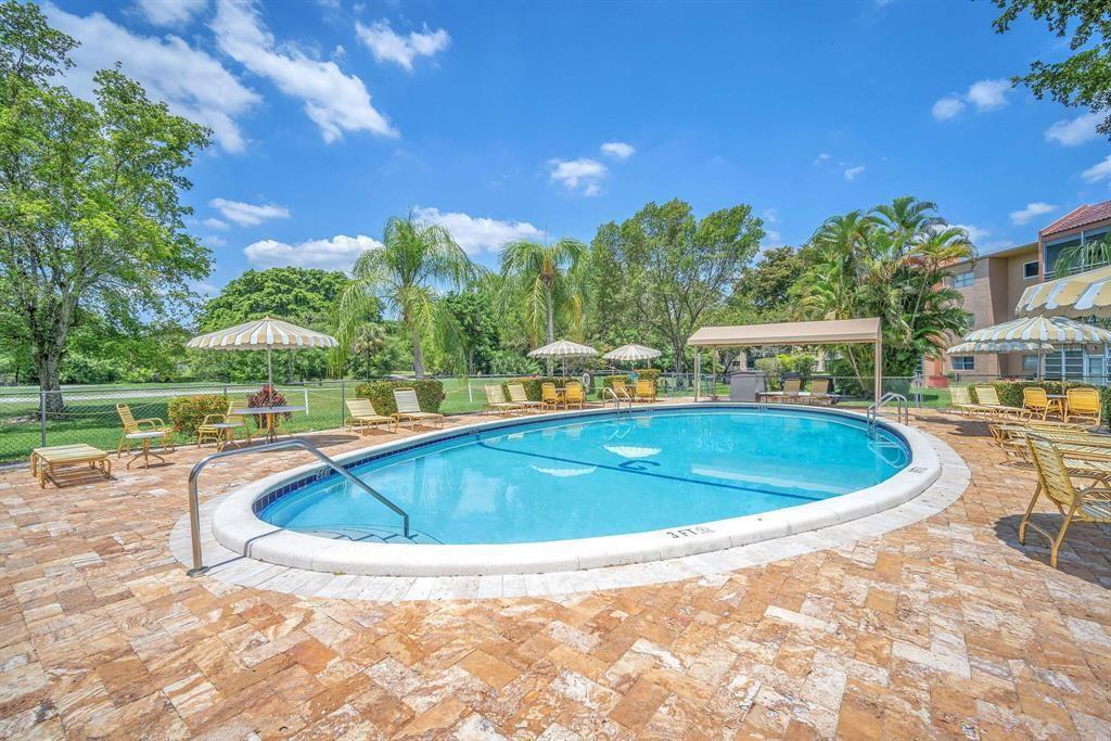 8810 West McNab Road, Unit 205 Tamarac, FL 33321 - Photo 11 of 11 a view of outdoor space yard swimming pool and outdoor seating