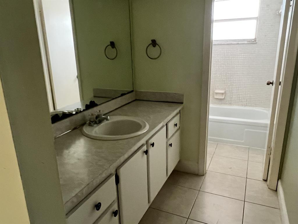8810 West McNab Road, Unit 205 Tamarac, FL 33321 - Photo 4 of 11 a bathroom with a sink and a mirror