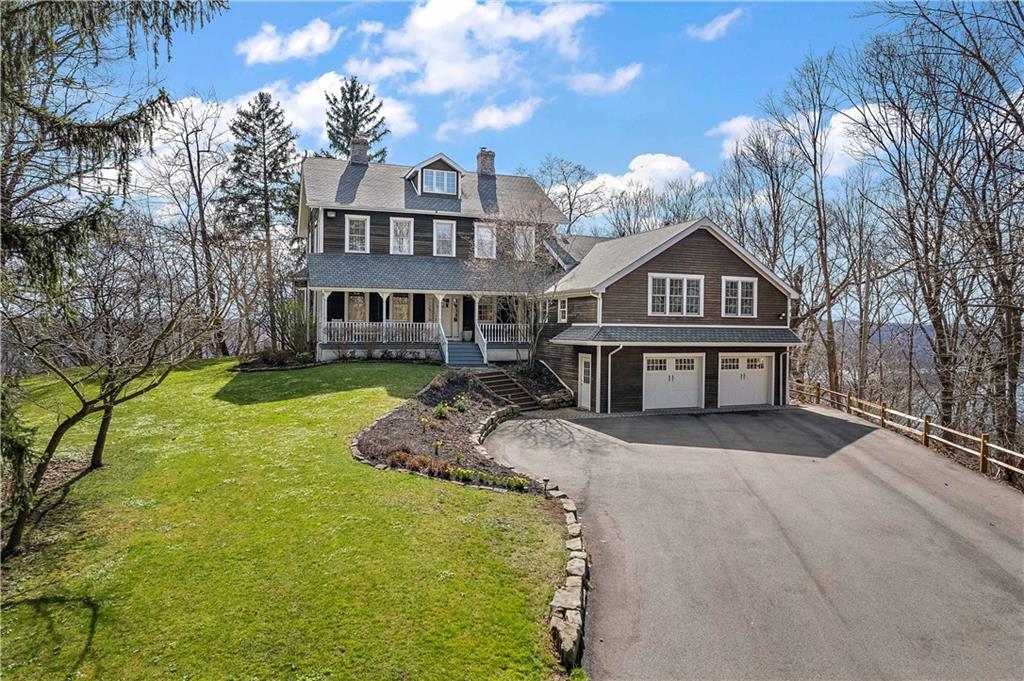 a view of a big house with a big yard and large tree