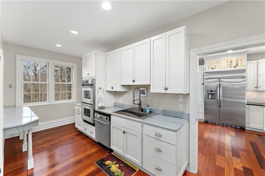 401 Redgate Road Sewickley, PA 15143 - Photo 27 of 50 a kitchen with granite countertop white cabinets and white appliances