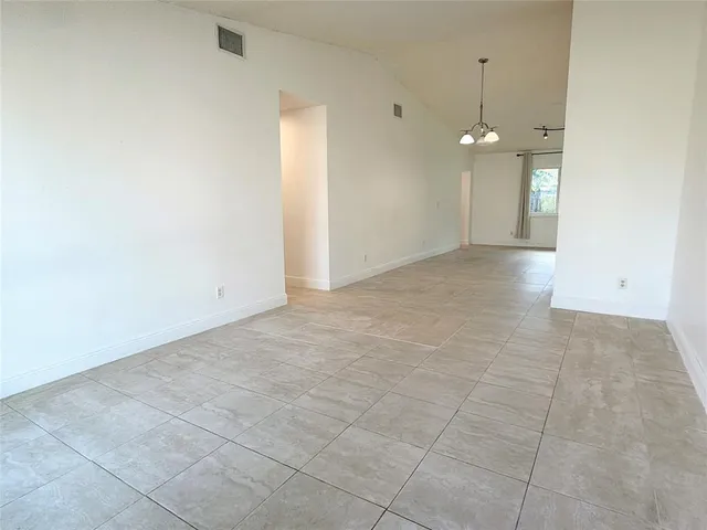 an empty room with white walls and tiles