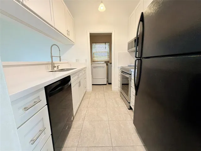 a kitchen with a sink a refrigerator and a stove