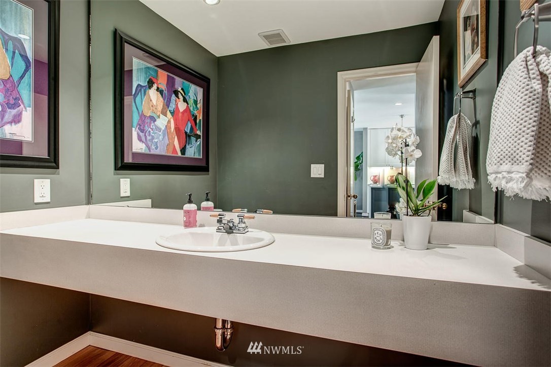1612 East McGraw Street Seattle, WA 98112 - Photo 14 of 21 a bathroom with a sink and a mirror