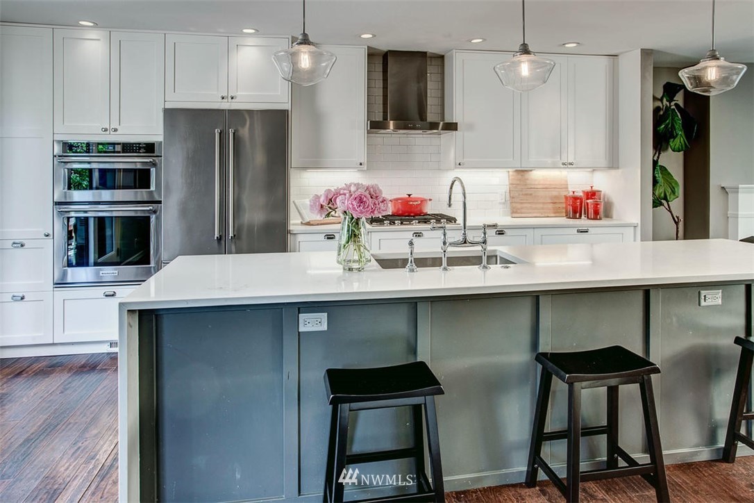 1612 East McGraw Street Seattle, WA 98112 - Photo 7 of 21 a kitchen with stainless steel appliances a sink and a refrigerator