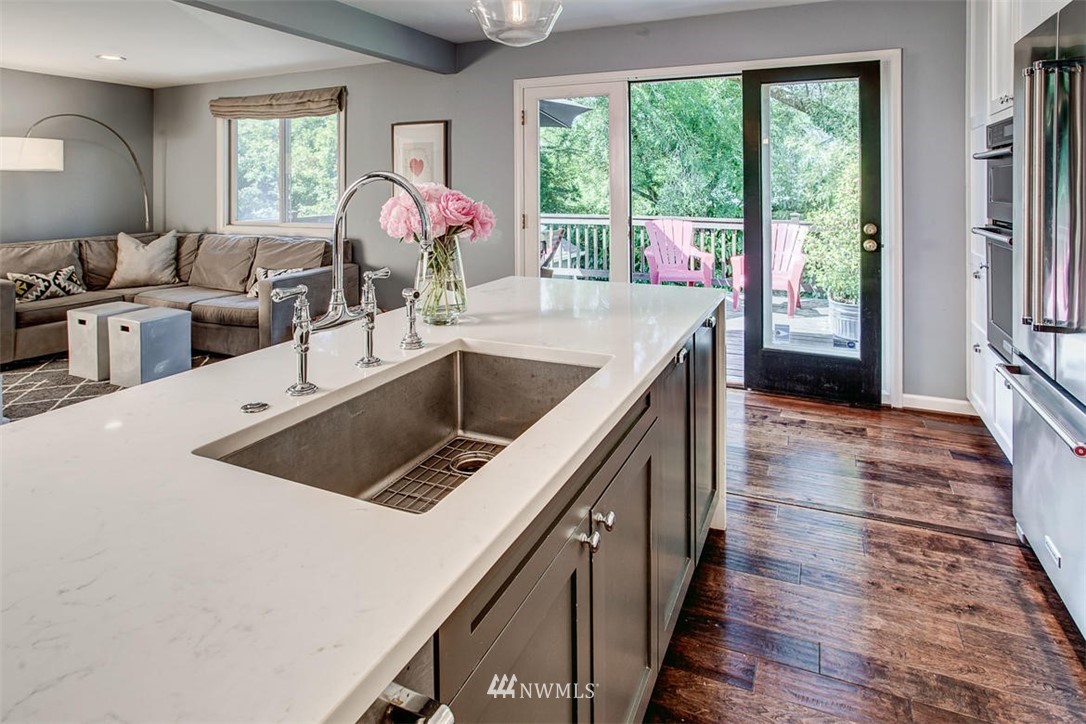 1612 East McGraw Street Seattle, WA 98112 - Photo 8 of 21 a kitchen with a stove a sink and a refrigerator