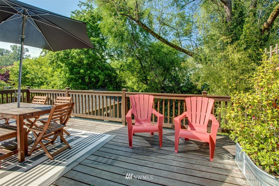 1612 East McGraw Street Seattle, WA 98112 - Photo 9 of 21 a balcony with wooden floor table and chairs