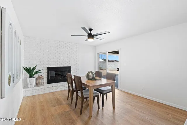 a dining room with furniture and a ceiling fan