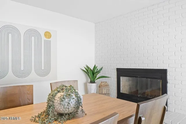 a bathroom with a sink a mirror and a potted plant
