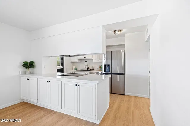 a kitchen with stainless steel appliances a refrigerator and cabinets
