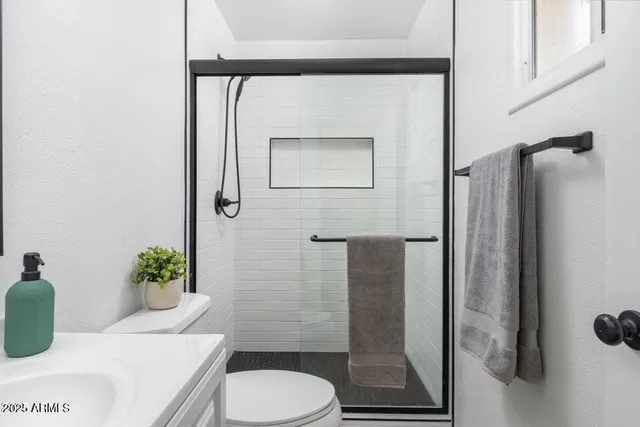 a bathroom with a toilet sink and shower