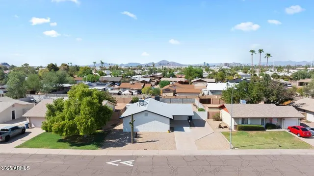 an aerial view of residential houses with city view