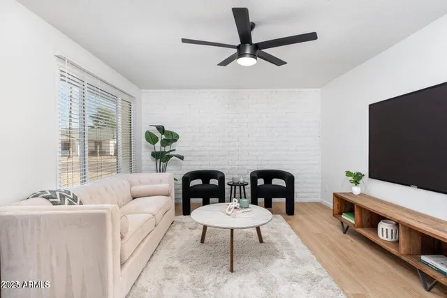 a living room with furniture and a flat screen tv