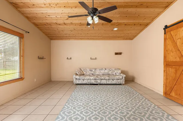 a living room with hard wood flooring and a table