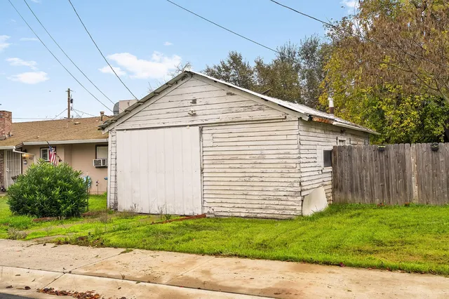a view of a white house with a yard