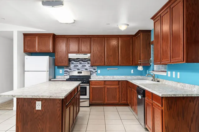 a kitchen with a sink stove and cabinets