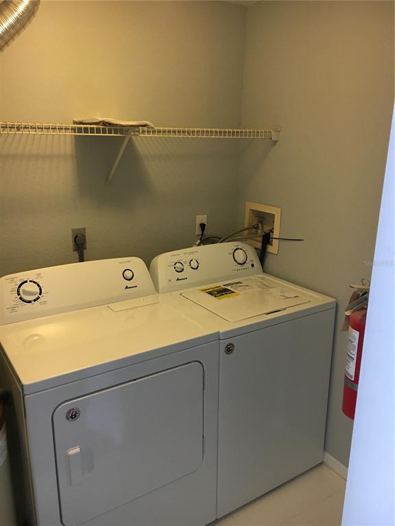 6304 Raleigh Street, Unit 204 Orlando, FL 32835 - Photo 14 of 29 a utility room with dryer and washer