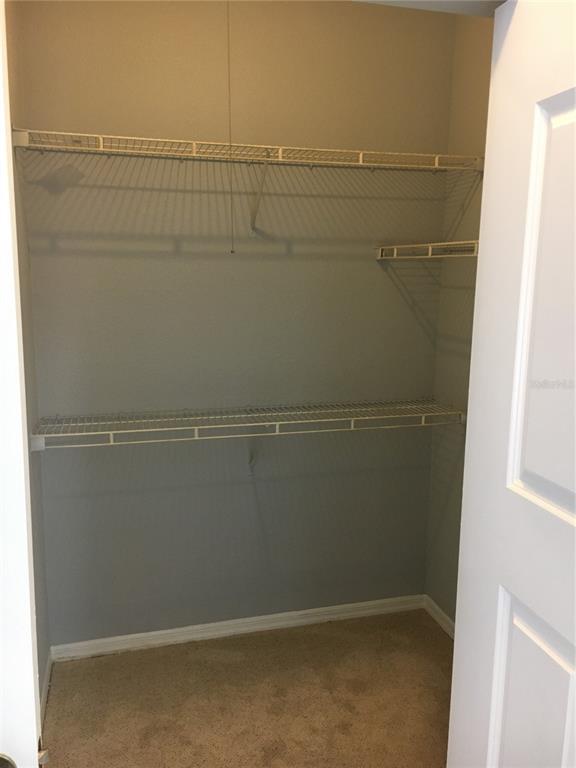 6304 Raleigh Street, Unit 204 Orlando, FL 32835 - Photo 21 of 29 a view of a room with racks on the wall