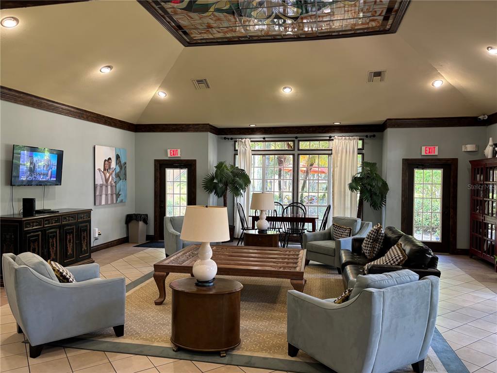 6304 Raleigh Street, Unit 204 Orlando, FL 32835 - Photo 23 of 29 a living room with furniture and a flat screen tv