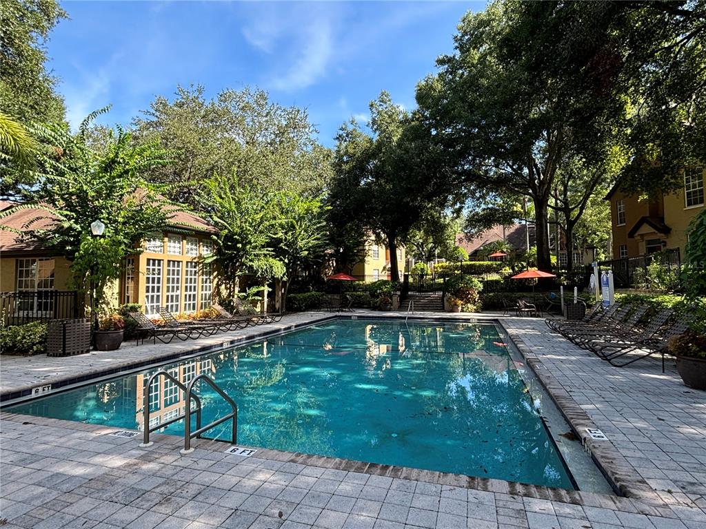 6304 Raleigh Street, Unit 204 Orlando, FL 32835 - Photo 27 of 29 a view of a house with backyard and sitting area