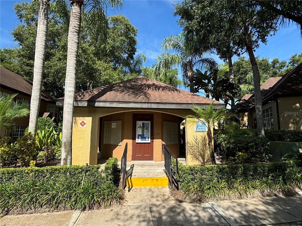 6304 Raleigh Street, Unit 204 Orlando, FL 32835 - Photo 29 of 29 a view of a house with large windows and a small yard