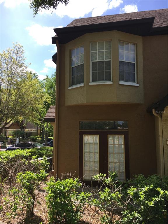 6304 Raleigh Street, Unit 204 Orlando, FL 32835 - Photo 5 of 29 a front view of a house with a yard