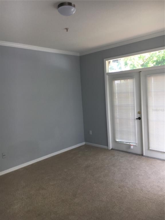6304 Raleigh Street, Unit 204 Orlando, FL 32835 - Photo 7 of 29 a view of an empty room with a window