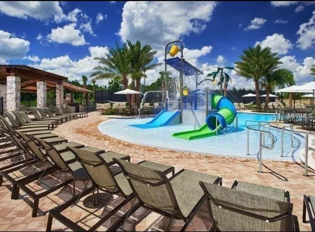 a view of a backyard with sitting area