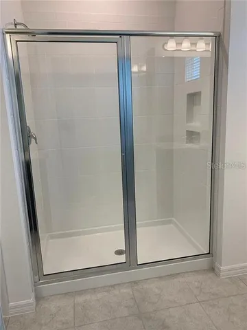 a bathroom with a glass shower door