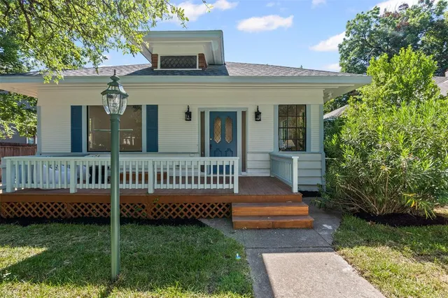 a view of a house with a yard and deck
