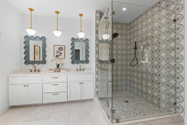 a bathroom with a mirror sink and double vanity