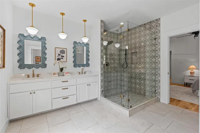 a spacious bathroom with double sink and shower
