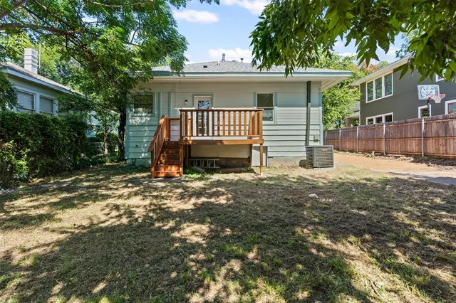 a view of a house with a yard and tree