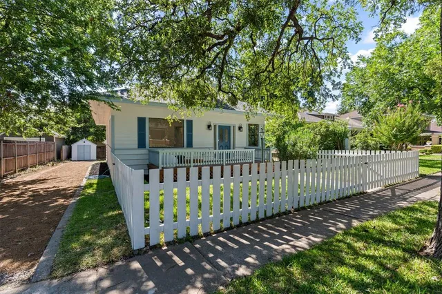 a view of a house with wooden fence