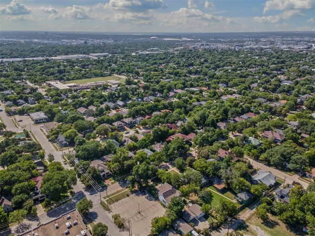 an aerial view of a houses with a yard