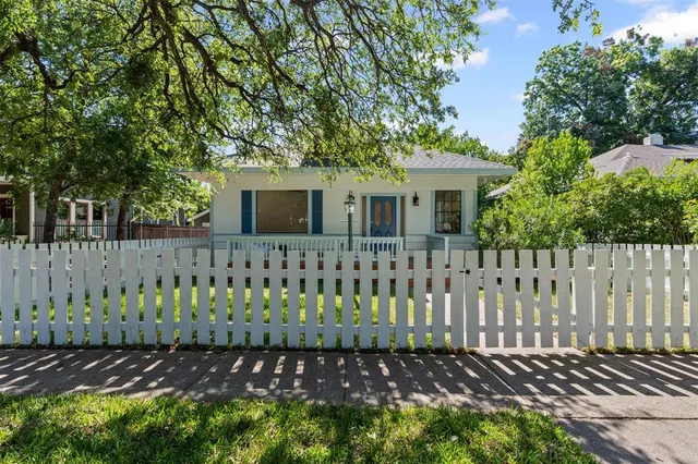 a front view of a house with a small yard