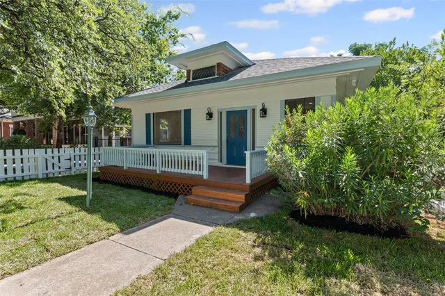 a view of a house with a yard and a garden