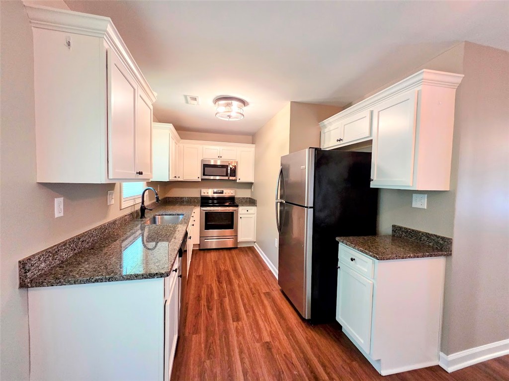 509 Elrod Road Piedmont, SC 29673 - Photo 8 of 28 Granite counters and wood flooring provide a polished look to this functional culinary space.
