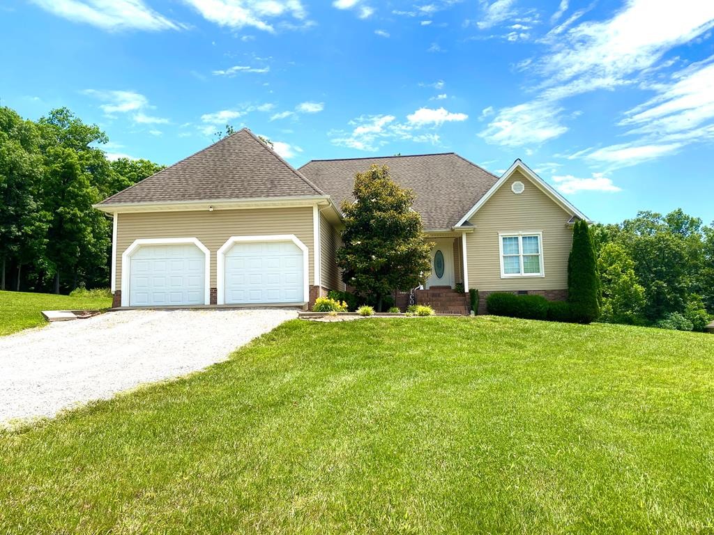 a front view of a house with a yard and garage