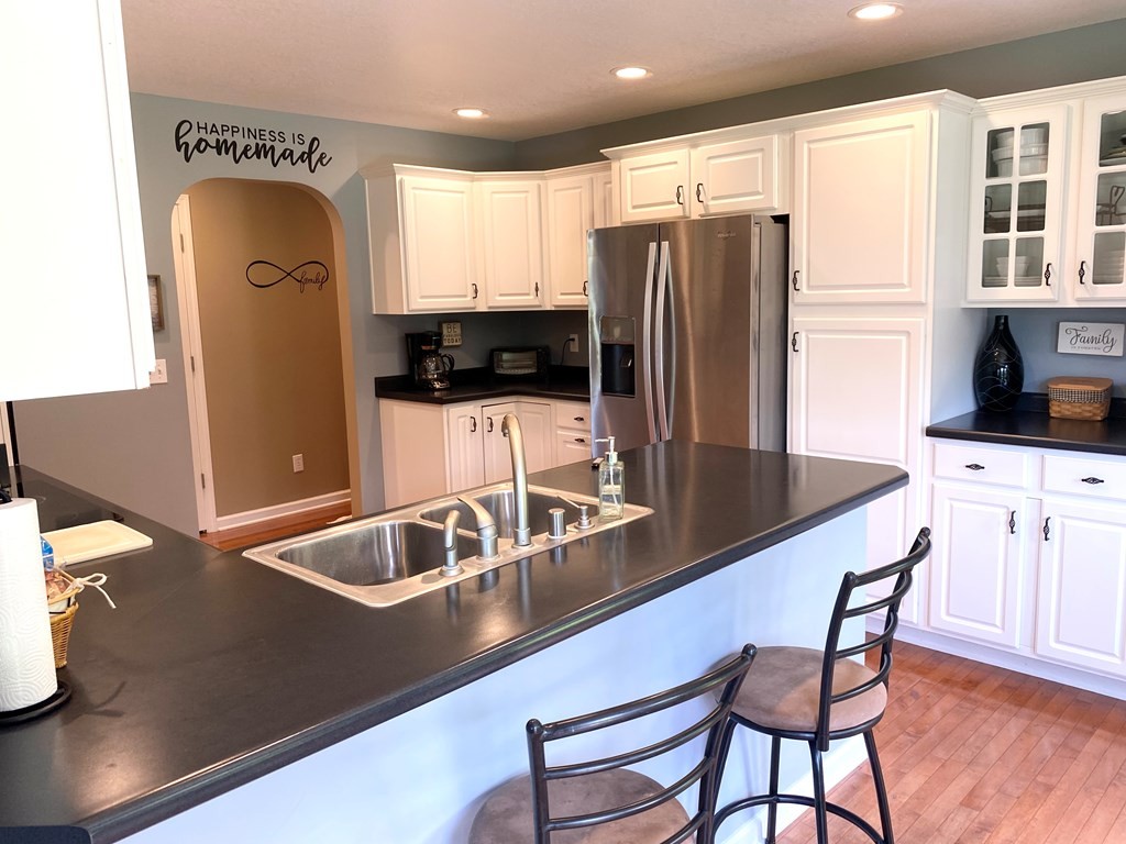 210 Clarks Store Sinking Fork Road Cerulean, KY 42215 - Photo 12 of 45 a kitchen with stainless steel appliances granite countertop a sink refrigerator and microwave