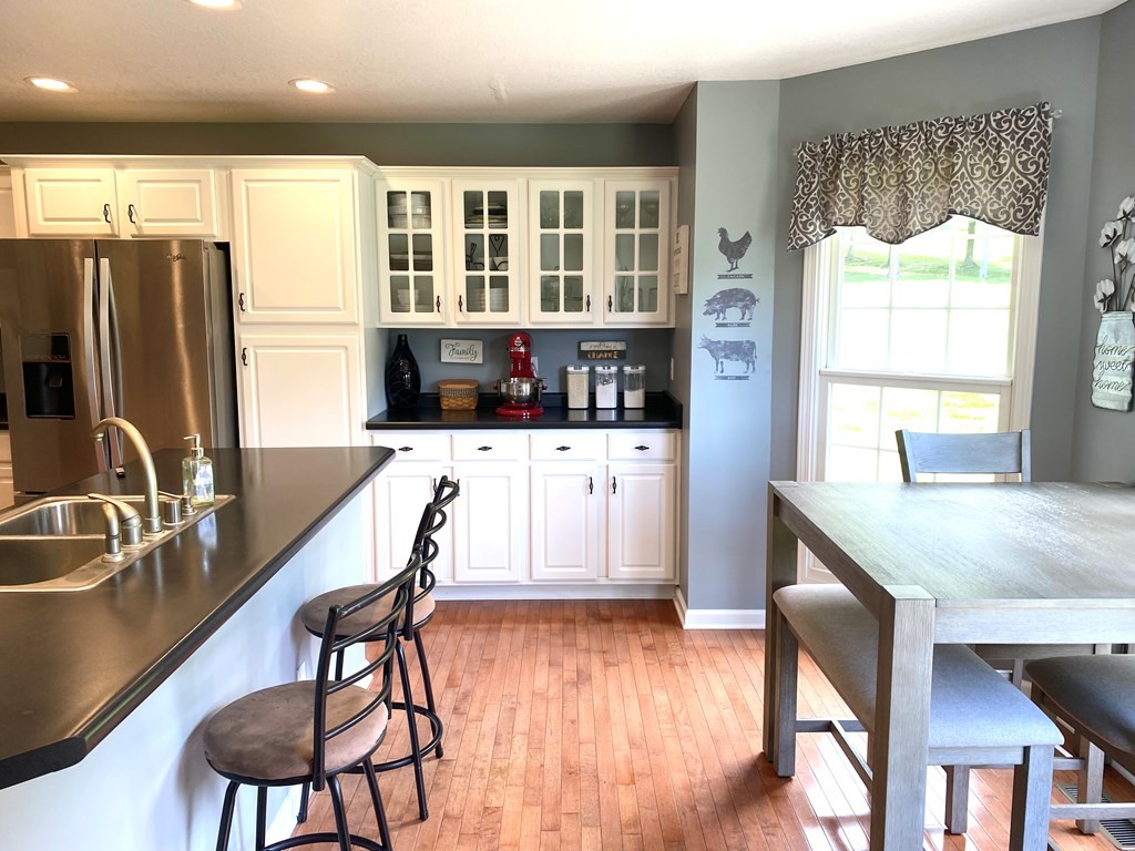 210 Clarks Store Sinking Fork Road Cerulean, KY 42215 - Photo 14 of 45 a kitchen with a table chairs refrigerator and cabinets