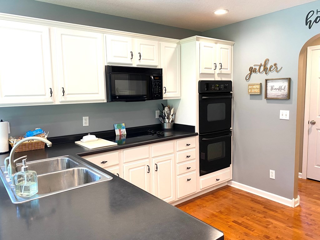210 Clarks Store Sinking Fork Road Cerulean, KY 42215 - Photo 17 of 45 a kitchen with stainless steel appliances a stove a sink and a microwave